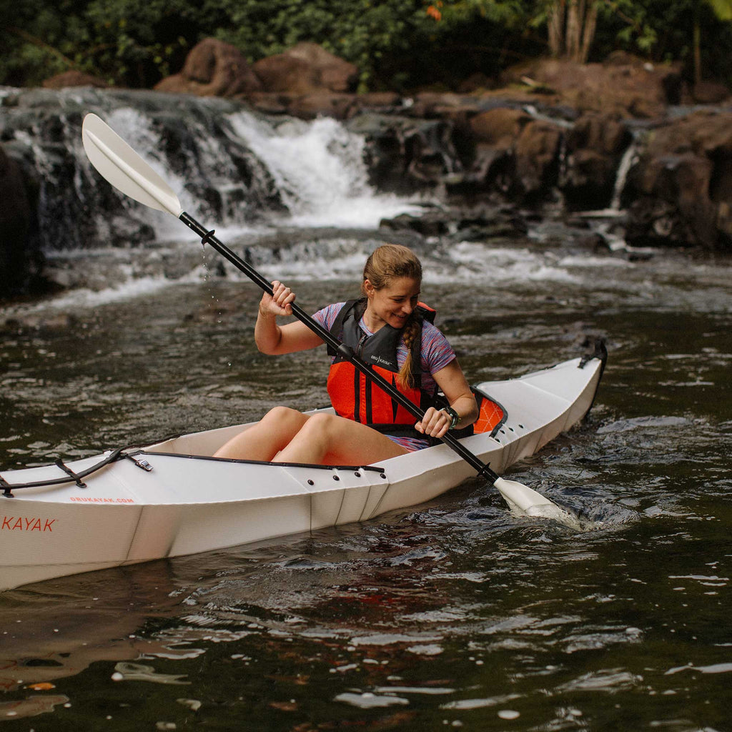 woman paddling on her beach lt kayak