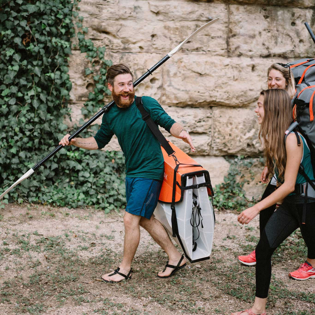 Group of people walking with their bay st kayaks