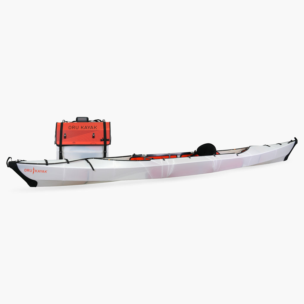 Side view of the Oru Kayak Haven model in white, shown fully assembled in front of its compact folded box form.