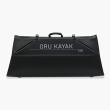 Folded white Oru Kayak Inlet model in black in box form.