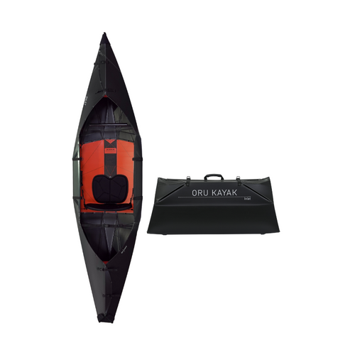 Top-down view of the Oru Kayak Inlet model in black, shown in both its fully assembled kayak form and its compact folded form, side by side.