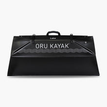 Folded white Oru Kayak Lake model in black in box form.
