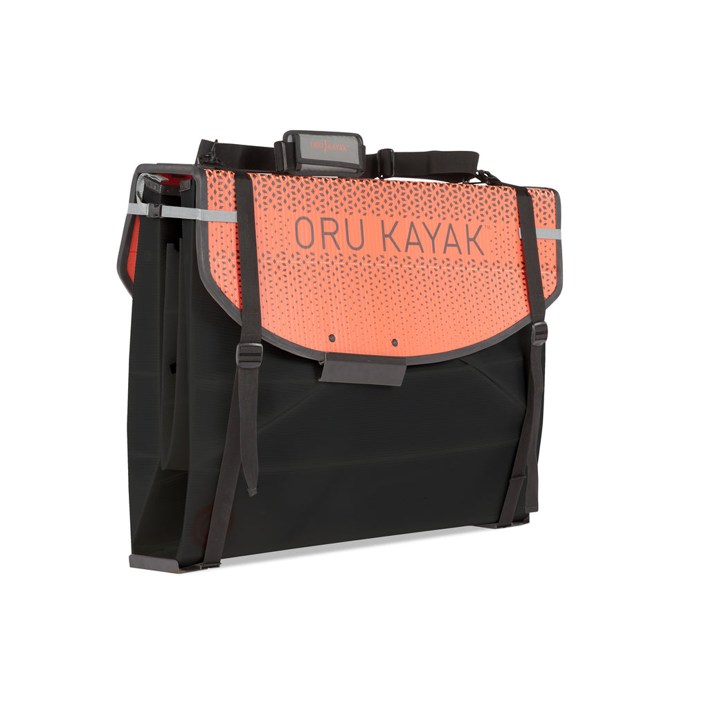 Folded white Oru Kayak Coast model in black in box form.