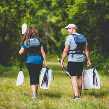 2 people carrying their inlet kayak folded