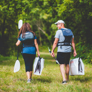 2 people carrying their inlet kayak folded